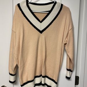 Light pink knee length sweater.